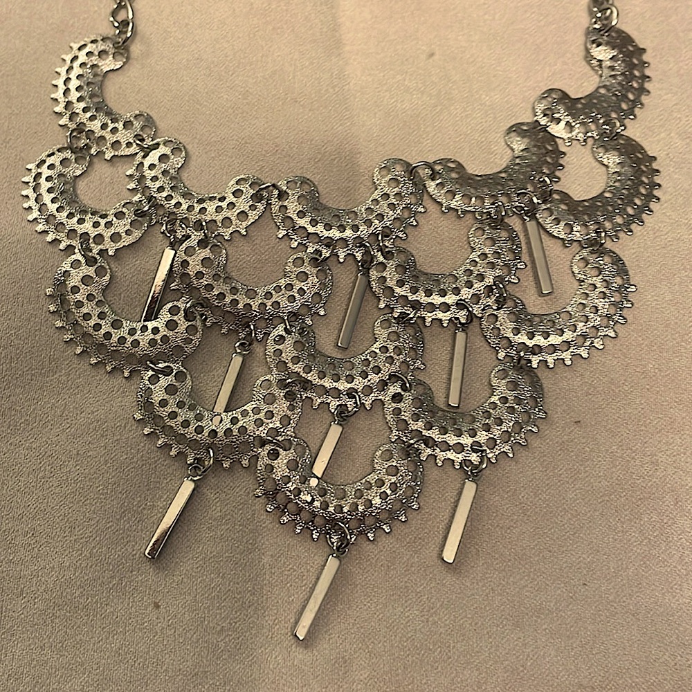 Two very unique silver tone necklaces one boho and the other is multi layer